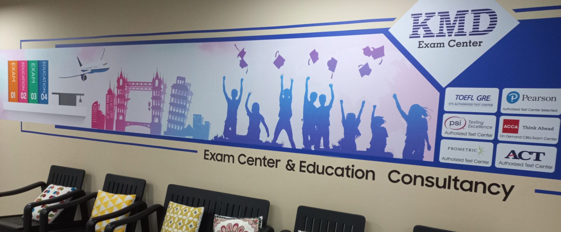 KMD Exam Center wall mural listing its TOEFL, Pearson, PSI, ACCA, Prometric and ACT accreditations